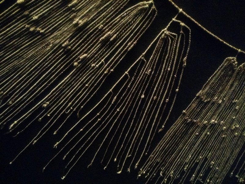 A portion of a *quipu* on display. The longest thread seen here is about a foot long.